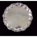 A GEORGE II SILVER SALVER Having a scalloped edge with shell motifs, bearing a family crest to