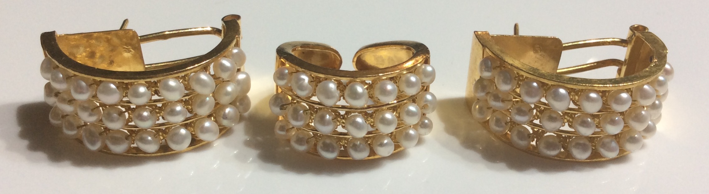 A BAHRAIN 21CT GOLD AND SEED PEARL EARRINGS AND RING SET Semi elliptical form, set with three rows