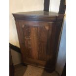 A GEORGIAN OAK AND SHELL INLAID CORNER CUPBOARD With reeded corners and a shelved interior, raised