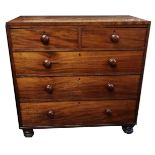 AN EARLY VICTORIAN MAHOGANY CHEST Of two short above three long drawers, raised on squat turned