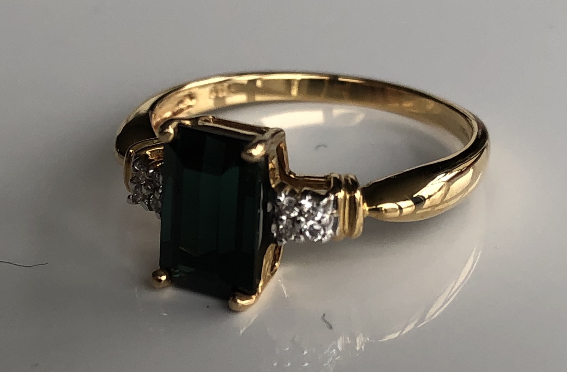 AN 18CT GOLD, ITATIAIA TOURMALINE AND DIAMOND RING The emerald cut tourmaline flanked by diamond