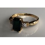 AN 18CT GOLD, ITATIAIA TOURMALINE AND DIAMOND RING The emerald cut tourmaline flanked by diamond