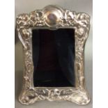 AN ART NOUVEAU DESIGN SILVER PLATED EASEL PHOTOGRAPH FRAME Having embossed floral decoration, marked