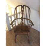 A VICTORIAN HOOP BACK WINDSOR CHAIR With pierced splat over a saddle seat, raised on turned legs