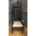 A RARE AND UNUSUAL CHINESE CARVED HARDWOOD CHAIR With pierced Gothic back flanked by turned