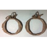 A PAIR OF 18TH CENTURY AFRICAN IRON CHILD'S SLAVE TRADE LEG SHACKLES The oval form with wire