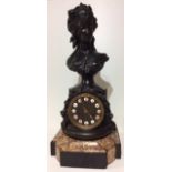 A 19TH CENTURY FRENCH SPELTER AND ROUGE MARBLE CLOCK Figured with a female bust above an enamelled