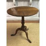 AN EARLY 19TH CENTURY MAHOGANY SUPPER TABLE The circular one piece tilt top, raised on a turned