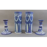 A PAIR OF 19TH CENTURY WEDGWOOD JASPERWARE SLEEVE VASES Dark blue grounds, applied with classical