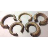 A COLLECTION OF FIVE AFRICAN BRONZE MANILLA CURRENCY BANGLES With rope work designs. (approx 8cm)