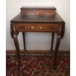 AN EDWARDIAN ROSEWOOD AND INLAID LADIES' WRITING TABLE With a single drawer, raised on cabriole