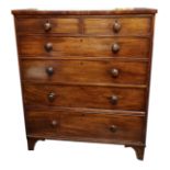 AN EARLY VICTORIAN MAHOGANY CHEST With two short above for long graduating drawers, raised on