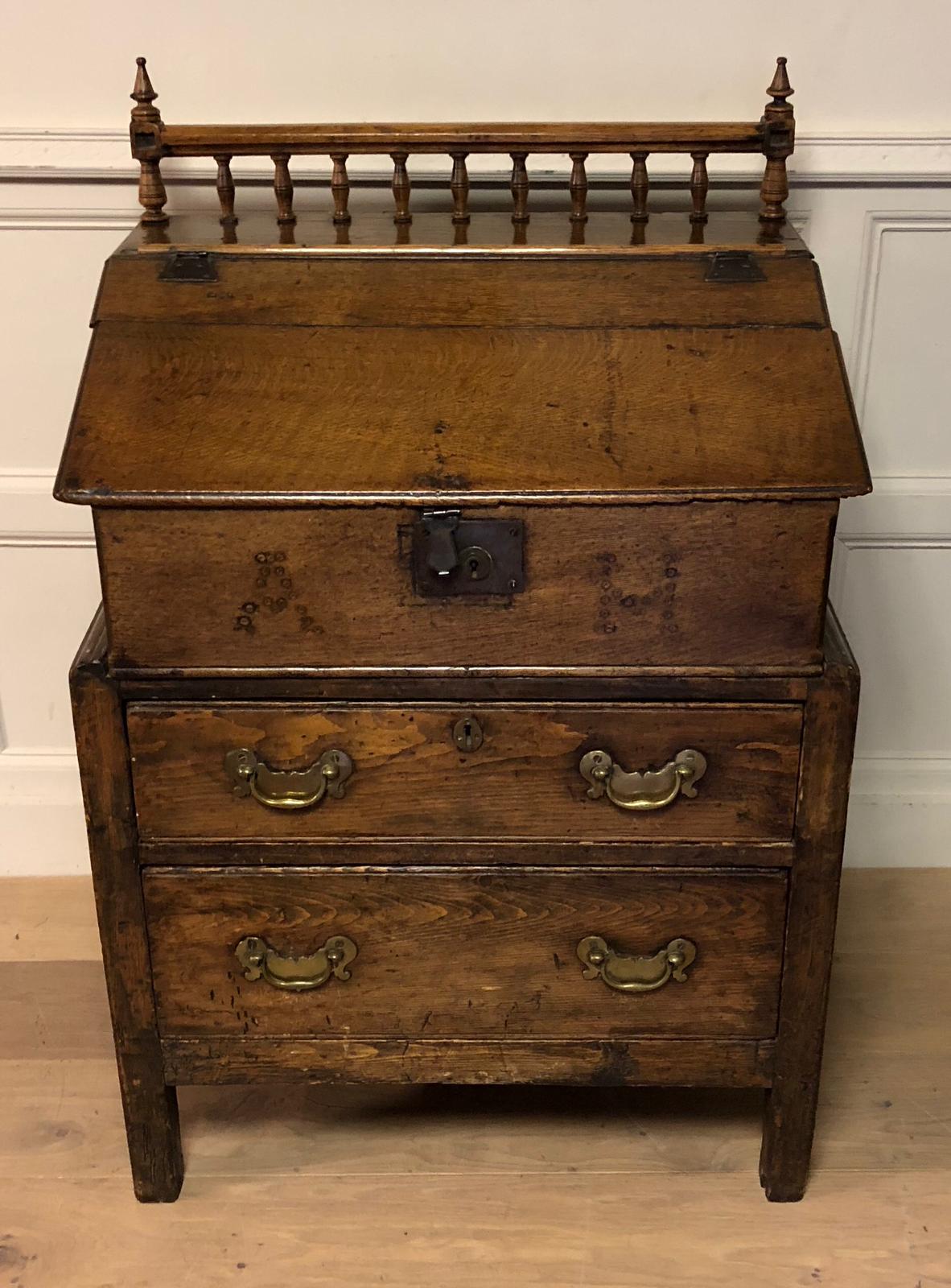 AN 18TH CENTURY LATER OAK BIBLE BOX ON PINE CHEST Of two drawers, the rising hinged lid opening to