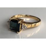 AN 18CT GOLD, ITATIAIA TOURMALINE AND DIAMOND RING The square cut tourmaline flanked by diamond