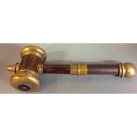 AN EARLY 20TH CENTURY OAK AND BRASS AUCTIONEER'S GAVEL Having a domed brass finial and caps. (approx