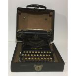 CORONA, AN EARLY 20TH CENTURY PORTABLE TYPEWRITER With fold-over top, contained in a carry case. (