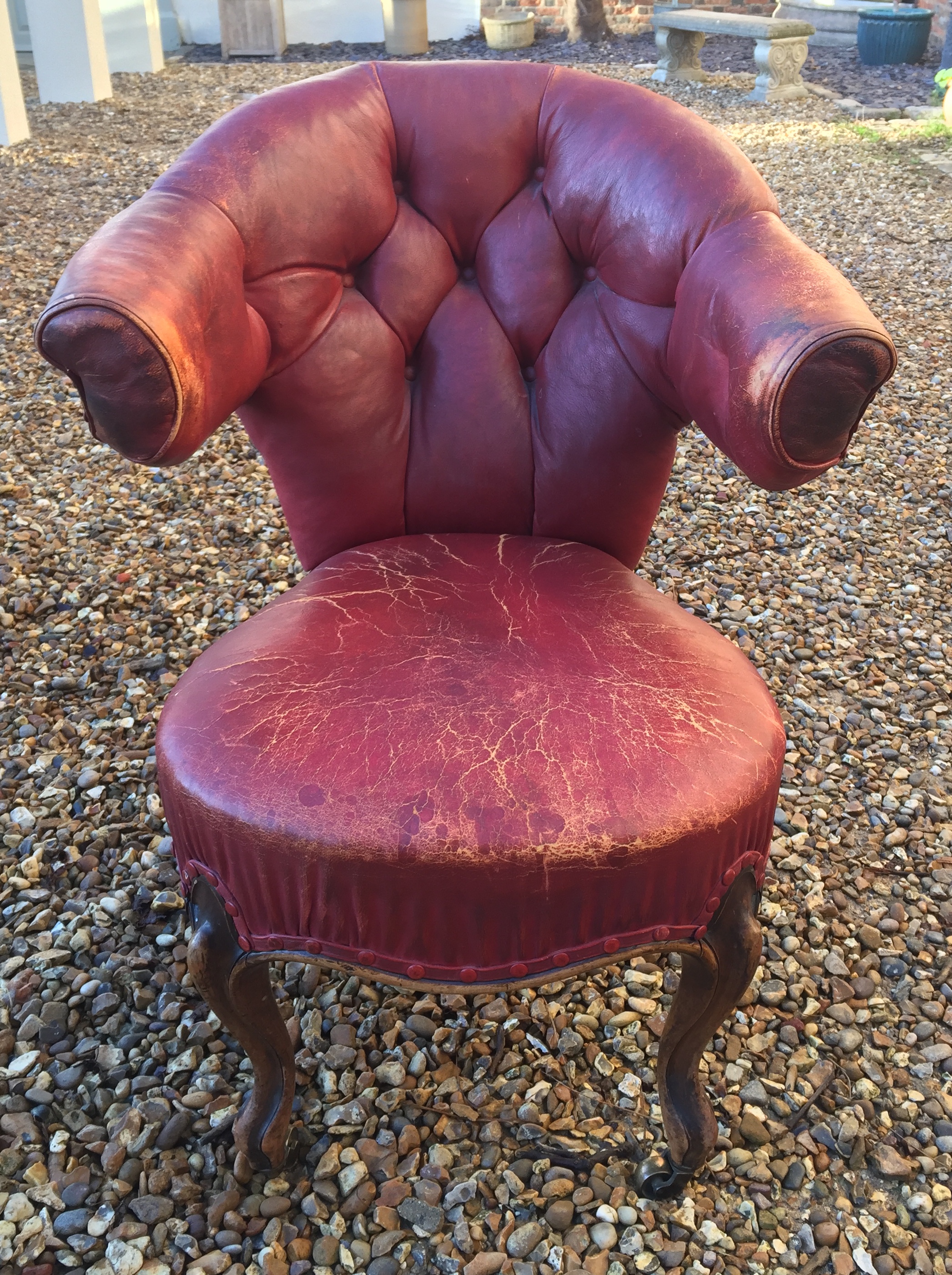 A 19TH CENTURY WALNUT AND RED LEATHER LIBRARY ARMCHAIR Button back upholstery, raised on carved - Image 2 of 2