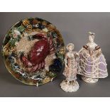 AN ANTIQUE CONTINENTAL PORCELAIN FIGURE OF A LADY Wearing 18th Century attire and clutching a fan,