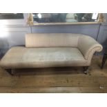 A VICTORIAN CHAISE LOUNGE With over scroll upholstered back, raised on turned mahogany legs