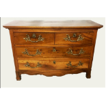 AN 18TH CENTURY FRENCH FRUIT WOOD CHEST OF TWO SHORT AND TWO LONG DRAWERS Fitted with heavy brass