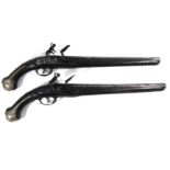 A PAIR OF MID 18TH CENTURY TURKISH FLINTLOCK PISTOLS The 34cm barrels with carved walnut stocks,