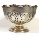 AN EDWARDIAN SILVER PEDESTAL BOWL Having scrolled edge and embossed decoration, hallmarked