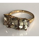 A 9CT GOLD, ZULTANITE AND WHITE SAPPHIRE RING The three large octagonal cut zultanites on white
