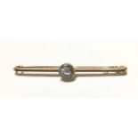 MAPPIN & WEBB, A VINTAGE 9CT GOLD AND AQUAMARINE BAR BROOCH The single round cut stone held on a