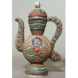 A PERSIAN WHITE METAL, CORAL, TURQUOISE AND LAPIS LAZULI COFFEE POT Having a scrolled handle and