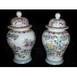 A PAIR OF CHINESE PORCELAIN VASES Decorated with figures and animals amongst trees. (h 40cm)