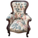 A VICTORIAN CARVED MAHOGANY ARMCHAIR With button back upholstery, raised on cabriole legs.