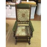 AN EARLY 20TH CENTURY AMERICAN DESIGN ROCKING CHAIR With floral upholstery and turned spindle