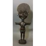 A CARVED WOODEN AFRICAN TRIBAL ART FERTILITY FIGURINE Female with disc form head, outstretched