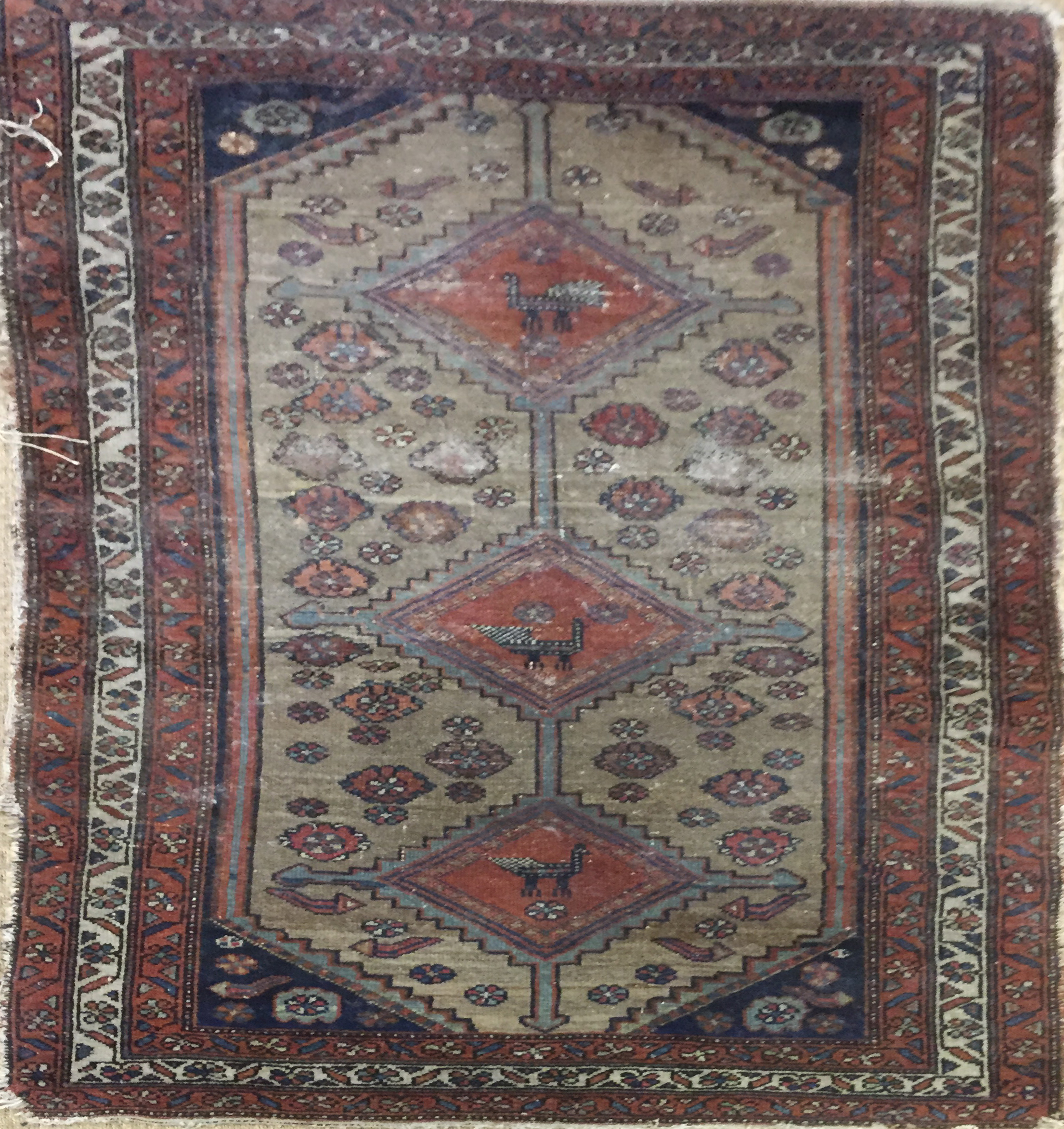 A MIDDLE EASTERN RUG Geometric design with three gulls, zoomorphic and floral decoration contained