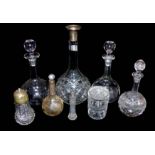 A COLLECTION OF FOUR EARLY 20TH CENTURY CUT GLASS DECANTERS Onion form with facets, one with a