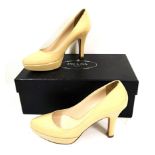 PRADA, A PAIR OF CREAM PATENT LEATHER PLATFORM COURT SHOES Boxed (size 36).