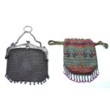 AN EARLY 20TH CENTURY SILVER MESH PURSE The rectangular form with spherical tassels, together with a