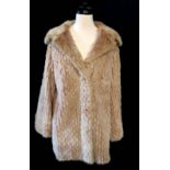 A VINTAGE BEIGE MINK SHORT COAT Fully reversible with a patchwork leather effect to one side.