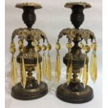 A PAIR OF 19TH CENTURY BRONZE ORMOLU LUSTRE CANDLESTICKS Having embossed floral and fruit decoration