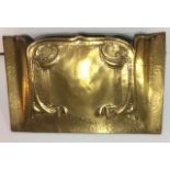 AN ART NOUVEAU BRASS FIRE HOOD Scrolled edge with embossed Macintosh rose design. (approx 45cm x