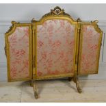 A LATE 19TH CENTURY LOUIS XIV GILTWOOD TRIPTYCH FIRE SCREEN The pierced central cartouche above silk