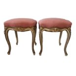 A PAIR OF 19TH CENTURY FRENCH PAINTED CARVED WOOD AND UPHOSTERED STOOLS Decorated with flowers and