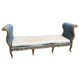 AN 18TH CENTURY FRENCH CARVED GILTWOOD DAYBED/WINDOW SEAT The scrolling arms decorated with