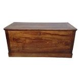 A LARGE EARLY 19TH CENTURY FRENCH FRUITWOOD FARMHOUSE COFFER/TRUNK With a hinged lid, raised on a