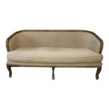 A FRENCH SETTEE WITH LIMED OAK FRAME In a mushroom cotton upholstery with loose cushions, raised