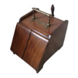 A VICTORIAN MAHOGANY AND BRASS COAL PERDONIUM Having twin opening doors and brass shovel.