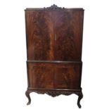 A REGENCY STYLE FLAME MAHOGANY DRINK’S CABINET With four doors, raised on cabriole legs. (88cm x