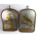 A PAIR OF DECORATIVE MIRRORS In the form of caged birds perched on keys. (24cm x 37cm)