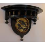 A VICTORIAN EBONISED AESTHETIC MOVEMENT WALL BRACKET With turned spindles above a parcel gilt