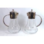 A PAIR OF SILVER PLATED WATER JUGS With internal ice liners. (24cm)